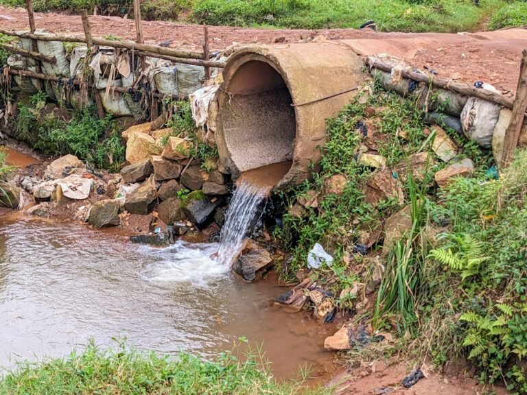 a large pipe is coming out of the water